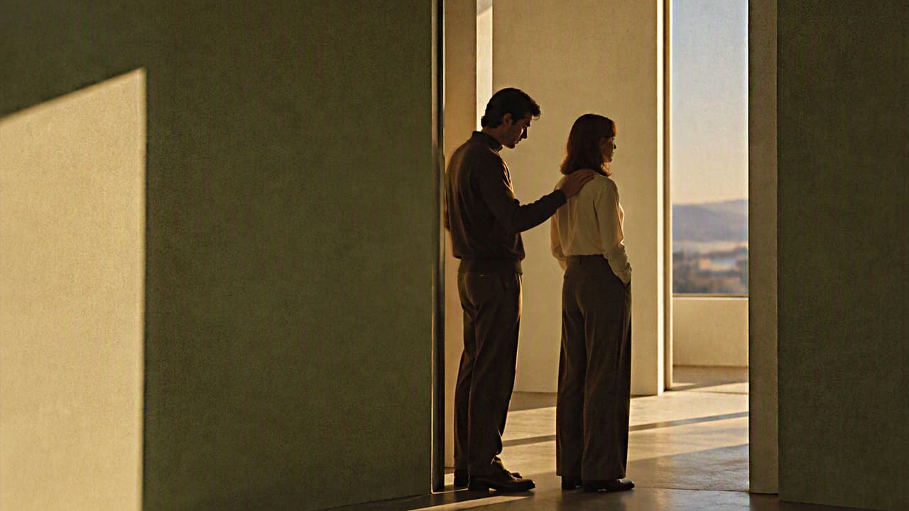 Couple reconnecting in a doorway, one resting a hand on the other's shoulder as they turn toward each other